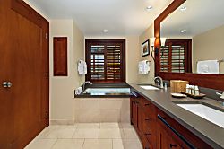 Beach Villas at Ko Olina O-1105 - The primary ensuite features soaking tub, walk in shower and dual vanity with storage.