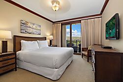 Beach Villas at Ko Olina O-1402 - Welcome to your bright and cheery primary guest bedroom with lanai and a TV.
