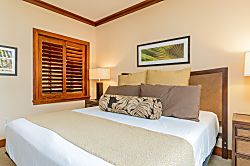Beach Villas at Ko Olina O-521 - Warm wood tones and tasteful decor in the primary guest bedroom.