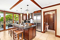 Beach Villas at Ko Olina B-308 - Tropical trees sway just beyond your prep space in this open-layout kitchen, designed for