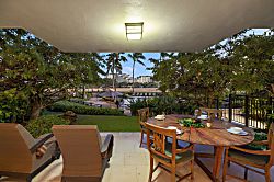 Beach Villas at Ko Olina B-107 - Lanai view with seating and loungers in a tropical paradise