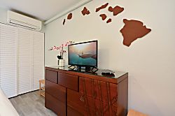 Napili Point B5 - Enjoy your favorite shows on the bedroom flat-screen TV, set on a dark wood dresser beneat