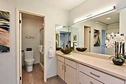 Napili Point B5 - The bathroom offers a wide vanity mirror, glass vessel sink, and a separate private area f