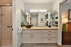Napili Point B5 - Clean vanity setup complete with a large wall mirror, stylish vessel sink, updated fixture