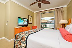 Honua Kai Hokulani 620 - Cozy bedroom retreat with balcony access and tropical TV scene.