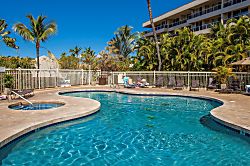Maui Banyan T304 - Sparkling pool area surrounded by swaying palms and tropical greenery, with plenty of loun