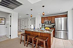 Honua Kai Konea 334 - Modern island kitchen with granite counters and warm wood touches and functionality for ev