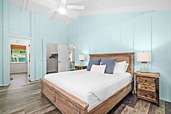 Hale Kanani Steps to Hanalei Bay  - Wake slowly in a room where plantation shutters filter the morning into something gentle.