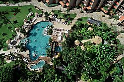 Aston Kaanapali Shores 1BO4 - Aerial view reveals a resort-style swimming pool with tropical landscaping, thatched palap