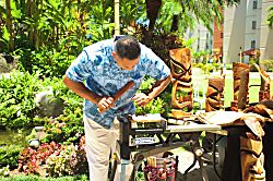 Aston Kaanapali Shores 1Br - A local artisan demonstrates traditional wood carving techniques in the lush tropical gard