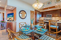 Kapalua Ridge Villas 1614 - The dining table is located directly across from the kitchen and breakfast bar