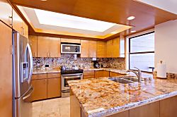 Kapalua Ridge Villas 1924 - The kitchen features beautiful recessed ceiling and lighting, and ocean views from the sin