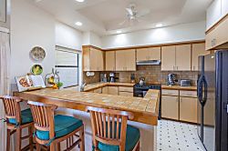 Kapalua Ridge Villas 1512 - Open kitchen seamlessly connected to dining and living areas, complete with a breakfast ba