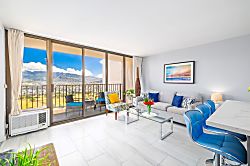 Waikiki Banyan 3401 T2 - Bright living room with mountain views and a balcony seating area.