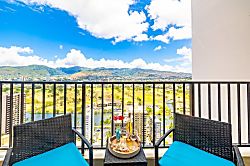Waikiki Banyan 3401 T2 - Relax on the balcony with mountain and city views in this bright setting.