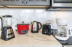 Waikiki Banyan 3401 T2 - Modern kitchen countertop with essential appliances including a blender, rice cooker, elec