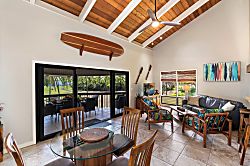 Kanaloa at Kona 1606 - Vaulted ceilings rise over the dining table, sliding doors opening to the light.