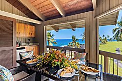 Kanaloa at Kona 1606 - A table set for six on the lanai, ocean framed just past the railing.
