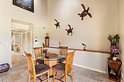 Kanaloa at Kona 1606 - The dining table sits near the entry, honu carvings watching over the room.