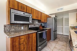 Kanaloa at Kona 1606 - A full run of counters, stainless appliances, and warm wood cabinetry, ready for a real me