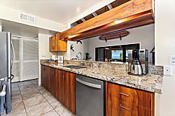 Kanaloa at Kona 1606 - Granite counters catch the morning light through the kitchen window.