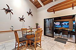 Kanaloa at Kona 1606 - Gather around the dining table, the lanai open just beyond the glass.