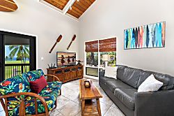 Kanaloa at Kona 1606 - Sliding doors open the living room straight onto the lanai and the greenery beyond.