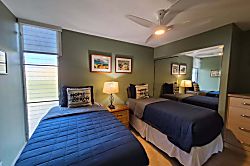 Island-Sands-606 - Unwind in your cozy bedroom with two comfortable beds and a gentle ceiling fan to keep you