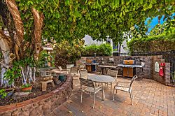 Kulakane 105 - Community BBQ grill surrounded by tropical greenery for casual cooking.