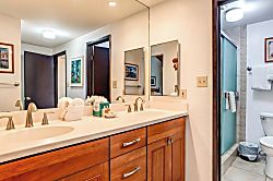 Napili Point NAP-C42 - Framed art, warm wood cabinetry, and light-filled sightlines make this guest bath feel bot