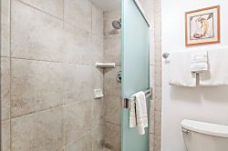 Napili Point NAP-C42 - Crisp white tile and a frosted glass enclosure create a timeless shower experience wrapped