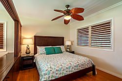 Hanalei Colony Resort K4  - bedroom with king bed - The bedroom has an additional ceiling fan, and slatted jalousie wi