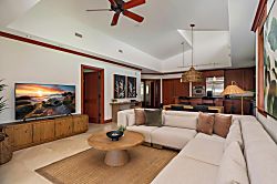 Kolea 11C - Settle into this airy living space where warm wood tones and vaulted ceilings create your