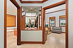 Kolea 11C - Step into your bright, open entryway with warm wood accents, mirrored details, and tropica