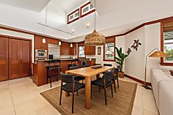Kolea 11C - Gather around the inviting dining table, where warm wood tones and island-inspired décor c