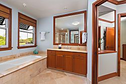 Kolea 11C - Your private spa-like bathroom features a soaking tub, elegant cabinetry, and natural ligh