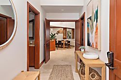Kolea 11C - Step inside a warm, inviting space where natural wood tones and coastal art create a welco