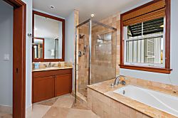 Kolea 11C - Soak away the day in your spa-inspired bathroom featuring warm tile, a walk-in glass showe