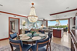 Beach Villas at Ko Olina B-604 - Gather around the elegant glass dining table under a stunning chandelier, while city views