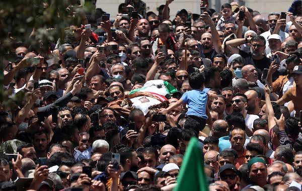 Thousands of Palestinian mourners attend funeral of Fatah party critic assassinated by PA officers in a home raid Thousands of Palestinian mourners attend funeral of Fatah party critic assassinated by PA officers in a home raid