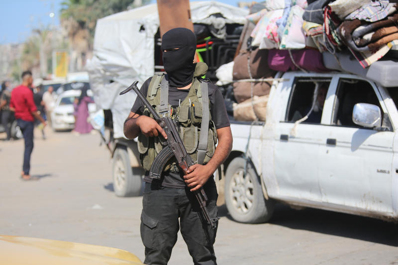Hossam al-Astal (C) surrounded by armed members of his militia, 'Strike Force Against Terror,' in an undated picture (Photo: Social media)