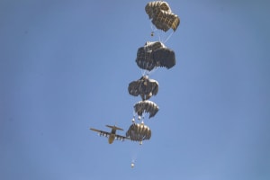 A plane drops humanitarian aid loaded with food supplies to displaced Palestinians in the northern Gaza Strip, July 27, 2025. Photo by Ali Hassan/Flash90