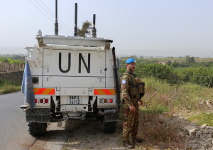 A UN peacekeeper stands next to a UN vehicle in Al Qulaylah in southern Lebanon, April 25, 2022. (Photo: Aziz Taher/Reuters)