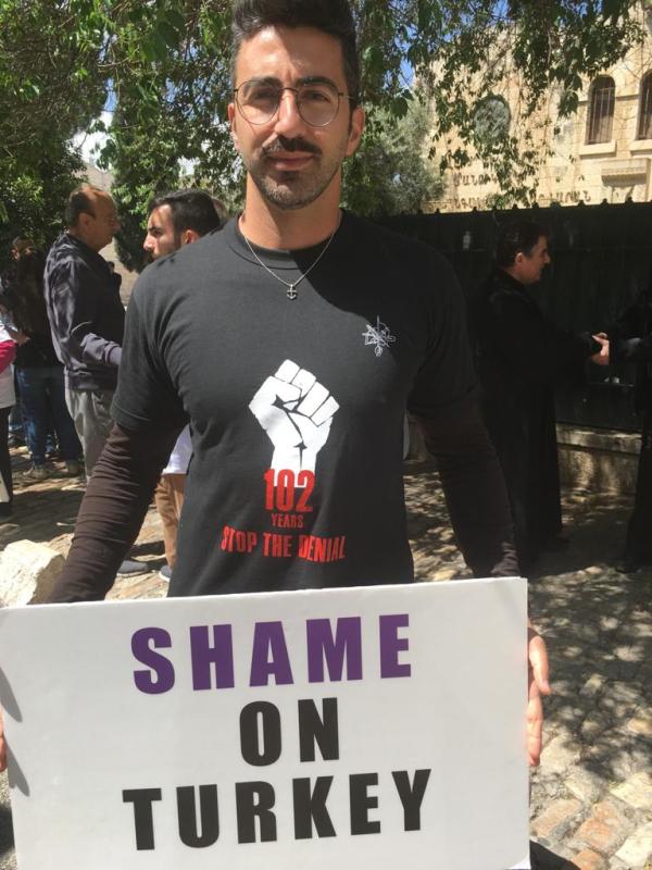Children hold up a sign during an observance of Armenian Genocide Memorial Day in the Old City of Jerusalem. (Photo: All Israel News)