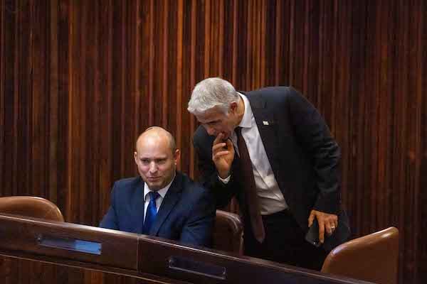 HISTORIC: Yesh Atid party leader Yair Lapid, Yamina party leader Naftali Bennett and Ra'am head Mansour Abbas after signing an agreement for a new government, June 2, 2021. (Photo: Ra’am party Twitter feed)