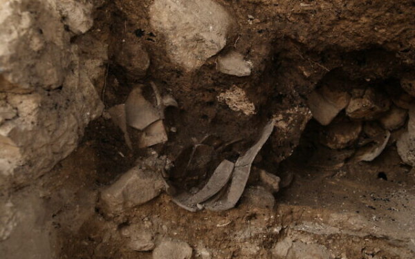 The excavation directors sitting on the exposed section of the first Temple-era protective wall on Jerusalem's eastern perimeter. (Photo: Yaniv Berman/Israel Antiquities Authority)