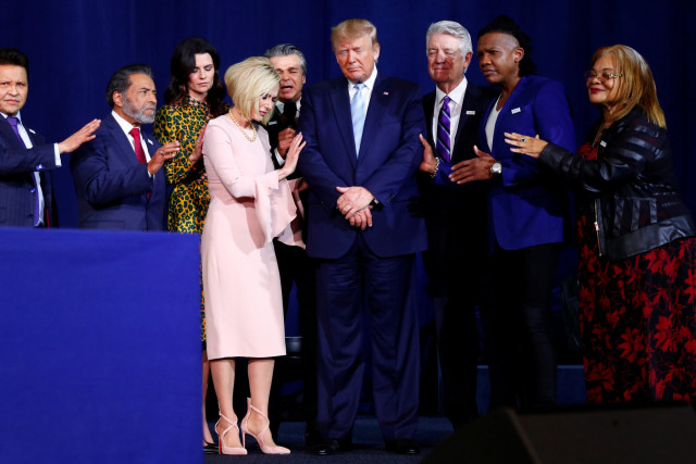 U.S. President Donald Trump participates in a prayer at an Evangelicals for Trump Coalition meeting in January 2020. (Photo: REUTERS/Tom Brenner)