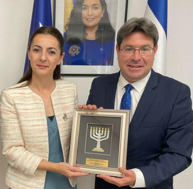 Ines Demiri, the Chargé D'affaires of Kosovo in Jerusalem, welcomes Israel's Minister of Regional Cooperation Ofir Akunis to the Embassy of Kosovo in Jerusalem. (Photo: Israel Ministry of Regional Cooperation)