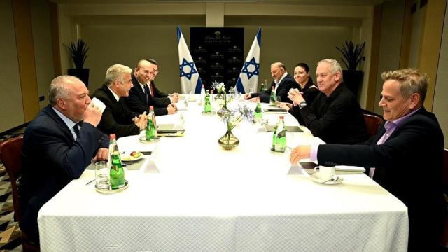 (L-R) Yisrael Beytenu leader Avigdor Liberman, Yesh Atid leader Yair Lapid, Yamina chair Naftali Bennett, New Hope chair Gideon Sa'ar, Blue and White head Benny Gantz, Ra’am chair Mansour Abbas, Labor head Merav Michaeli and Meretz leader Nitzan Horowitz at a meeting of the heads of the would-be-coalition in Tel Aviv, June 6, 2021. (Yesh Atid Twitter feed)