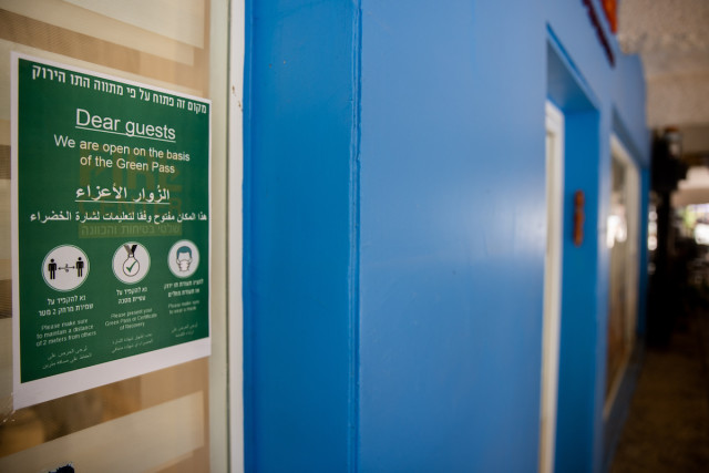 A green pass sign at the entrance to a shop in Jerusalem on Aug. 4, 2021. (Photo: Yonatan Sindel/Flash90)
